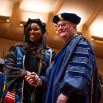 A graduate poses with UCSF Chancellor Sam Hawgood, MBBS